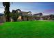 Charming home featuring a manicured lawn, mature palm trees, and a spacious two-car garage at 8711 Thornwood Ln, Tampa, FL 33615