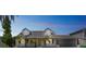 Charming home featuring a manicured lawn, mature palm trees, and a spacious two-car garage at 8711 Thornwood Ln, Tampa, FL 33615