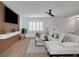 Bright living room featuring modern decor, plank flooring, and a ceiling fan at 8711 Thornwood Ln, Tampa, FL 33615