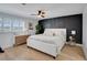 Modern main bedroom featuring dark accent wall, wood floors, and shuttered windows at 8711 Thornwood Ln, Tampa, FL 33615