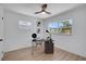 Home office with wood floors, modern desk, chair and natural light from two windows at 8711 Thornwood Ln, Tampa, FL 33615
