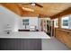 Outdoor kitchen featuring wood ceilings, stainless steel grill, countertops and wine storage at 8711 Thornwood Ln, Tampa, FL 33615