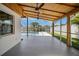 Outdoor patio overlooking the pool with ceiling fans and lots of space at 8711 Thornwood Ln, Tampa, FL 33615
