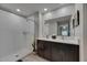 Bright bathroom featuring a walk-in shower and double vanity with modern fixtures and white marble countertops at 872 Olive Conch St, Ruskin, FL 33570