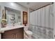 Bathroom showcasing granite counters, dark cabinetry, mirror, and a shower and tub combo at 872 Olive Conch St, Ruskin, FL 33570