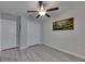 Neutral bedroom featuring a ceiling fan, closet, and gray floors at 872 Olive Conch St, Ruskin, FL 33570