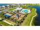 Aerial shot of community center featuring a pool, playground, and lake views at 872 Olive Conch St, Ruskin, FL 33570