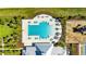 Aerial view showcasing a community pool, ample lounge chairs, and a nearby playground for outdoor fun at 872 Olive Conch St, Ruskin, FL 33570