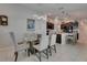 Bright dining area with modern chandelier, seating for six, and an adjacent kitchen at 872 Olive Conch St, Ruskin, FL 33570