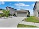 A single-story home featuring a two-car garage and meticulously maintained landscaping at 872 Olive Conch St, Ruskin, FL 33570