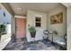 Inviting front porch with slate tile, seating area, and a beautifully painted front door at 872 Olive Conch St, Ruskin, FL 33570