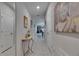 Inviting hallway with elegant decor and light tile flooring leading to the living areas at 872 Olive Conch St, Ruskin, FL 33570