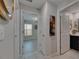 Open hallway featuring views of the bedroom and bathroom and white tiled floors at 872 Olive Conch St, Ruskin, FL 33570