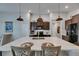 Spacious kitchen island featuring seating and pendant lighting with view of modern kitchen at 872 Olive Conch St, Ruskin, FL 33570