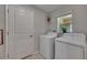 Bright laundry room featuring modern appliances, window and ample space at 872 Olive Conch St, Ruskin, FL 33570