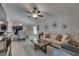 Open-concept living room featuring stylish decor, a ceiling fan, and lots of natural light at 872 Olive Conch St, Ruskin, FL 33570