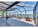 A covered patio with lake views, outdoor furniture, and a hot tub at 872 Olive Conch St, Ruskin, FL 33570