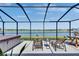 The screened-in patio offers a relaxing space with seating, a hot tub, and scenic lake views at 872 Olive Conch St, Ruskin, FL 33570