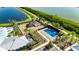 Aerial view highlighting the community playground, tennis court, and surrounding lush greenery near the lake at 872 Olive Conch St, Ruskin, FL 33570
