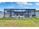 Screened-in lanai with outdoor furniture, spa, and seating area at 872 Olive Conch St, Ruskin, FL 33570