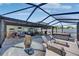 Lanai with outdoor furniture, spa, grill, and seating area at 872 Olive Conch St, Ruskin, FL 33570