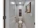 Small half-bathroom featuring toilet and wall decor at 872 Olive Conch St, Ruskin, FL 33570