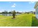 Picturesque backyard featuring a tranquil pond and lush green lawn, perfect for relaxation and enjoying nature at 8916 Windlass Cv, Parrish, FL 34219