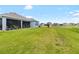 Large backyard with green lawn and view of neighboring homes, great for outdoor activities and recreation at 8916 Windlass Cv, Parrish, FL 34219