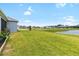 Expansive backyard overlooking a tranquil pond, providing a serene and picturesque setting at 8916 Windlass Cv, Parrish, FL 34219