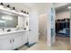 Elegant bathroom with double vanity, walk-in shower, and entrance to a walk-in closet at 8916 Windlass Cv, Parrish, FL 34219