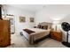 Cozy bedroom with neutral tones, wood accents, and a bathroom ensuite at 8916 Windlass Cv, Parrish, FL 34219