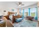 Spacious bedroom with a wood bed frame, blue accents, and three windows offering natural light at 8916 Windlass Cv, Parrish, FL 34219