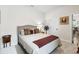 Comfortable bedroom with neutral tones, cozy bedding, and a quaint bedside table at 8916 Windlass Cv, Parrish, FL 34219