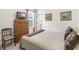 Inviting bedroom featuring a wood dresser, a TV, and decorative artwork on the walls at 8916 Windlass Cv, Parrish, FL 34219