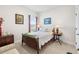 Charming bedroom with vintage furniture, soft lighting, and picturesque artwork at 8916 Windlass Cv, Parrish, FL 34219