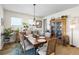 Charming dining room with elegant wood table, decorative cabinet, and chandelier lighting at 8916 Windlass Cv, Parrish, FL 34219
