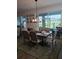 Formal dining room with elegant seating, decorative lighting, and serene views, ideal for hosting memorable gatherings at 8916 Windlass Cv, Parrish, FL 34219
