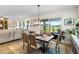 Bright dining room with wood table, chandelier, and large window overlooking the backyard at 8916 Windlass Cv, Parrish, FL 34219