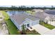 Home exterior overlooking water with nice landscaping and an attached two-car garage at 8916 Windlass Cv, Parrish, FL 34219