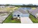 Beautifully landscaped home exterior with a manicured lawn, and a two-car garage at 8916 Windlass Cv, Parrish, FL 34219