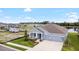 Beautiful landscaped home exterior with a manicured lawn, and a two-car garage at 8916 Windlass Cv, Parrish, FL 34219