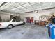 Spacious two car garage featuring plenty of storage space, tool storage, and a clean epoxy floor at 8916 Windlass Cv, Parrish, FL 34219