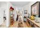 Long hallway featuring wood floors, elegant decor, and seamless transition to other living spaces, showcasing spaciousness at 8916 Windlass Cv, Parrish, FL 34219