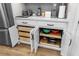 The kitchen area showcases customized pull-out shelving and easy storage accessibility behind clean white cabinets at 8916 Windlass Cv, Parrish, FL 34219