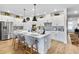 Bright kitchen with stainless steel appliances, white cabinets, an island with seating, and pendant lighting at 8916 Windlass Cv, Parrish, FL 34219
