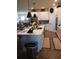 Modern kitchen boasts white cabinets, a spacious island and stainless steel appliances with easy access to living spaces at 8916 Windlass Cv, Parrish, FL 34219