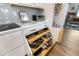 The kitchen boasts customized pull-out shelving and sleek countertops, adding function and style to meal preparation at 8916 Windlass Cv, Parrish, FL 34219