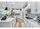 Bright kitchen featuring white cabinets, quartz countertops, stainless steel appliances, and modern fixtures at 8916 Windlass Cv, Parrish, FL 34219