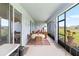 Screened lanai with a dining area and comfortable seating, perfect for outdoor relaxation and entertaining at 8916 Windlass Cv, Parrish, FL 34219