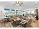 Bright living room features comfortable seating, a large window overlooking a lake, and stylish decor at 8916 Windlass Cv, Parrish, FL 34219